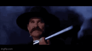 A Man In A Hat Is Holding A Gun And Saying Clouds Comin ' With Me . GIF