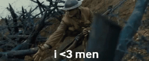 A Man In A Hat Is Holding A Rifle In A Field And Says `` I < 3 Men '' . GIF