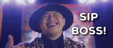 A Man In A Hat Is Laughing And Giving A Thumbs Up While Saying `` Sip Boss '' . GIF