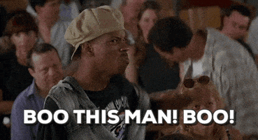 A Man In A Hat Is Sitting In A Crowd And Says Boo This Man Boo ! GIF