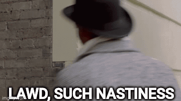 A Man In A Hat Is Standing In Front Of A Brick Wall And Says `` Lawd , Such Nastiness '' . GIF