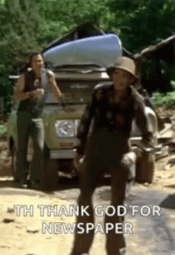A Man In A Hat Is Standing In Front Of A Truck With A Newspaper On The Back . GIF