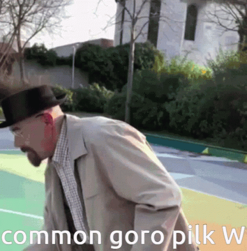 A Man In A Hat Is Standing On A Basketball Court With The Words Common Goro Pilk W Written Below Him GIF