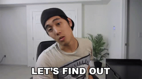 A Man In A Hat Says Let 'S Find Out In Front Of A Plant GIF