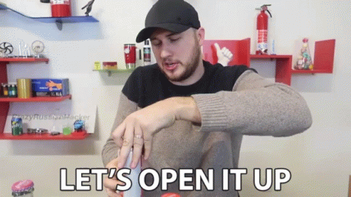 a man in a hat says let 's open it up while holding something