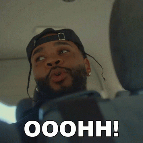 A Man In A Hat Says Ooohh In Front Of His Face GIF