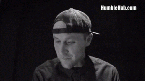a man in a hat says we are human after all in a black and white photo