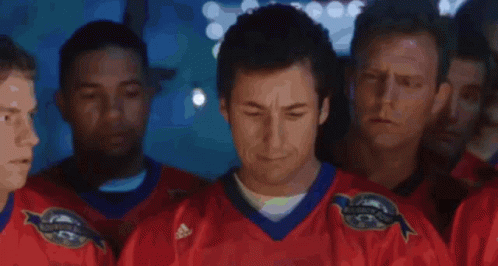 A Man In A Hat Stands In Front Of A Crowd And Says We Suck Again GIF