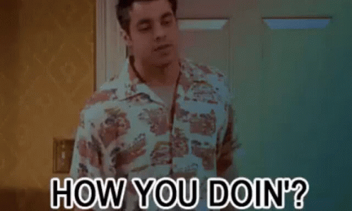 a man in a hawaiian shirt is standing in front of a door and asking how you doin ?