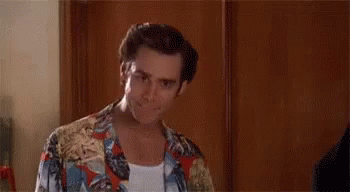 A Man In A Hawaiian Shirt Is Standing In Front Of A Wooden Wall And Saying `` Alright Then ! '' GIF