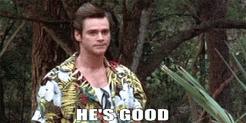 A Man In A Hawaiian Shirt Is Standing In The Woods And Saying He 'S Good . GIF