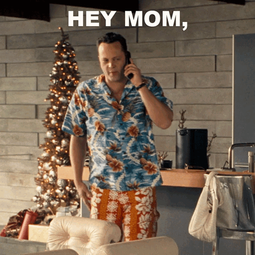 A Man In A Hawaiian Shirt Is Talking On A Cell Phone And The Words Hey Mom Are Above Him GIF