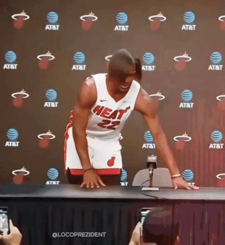 A Man In A Heat Jersey Stands In Front Of An At & T Backdrop GIF