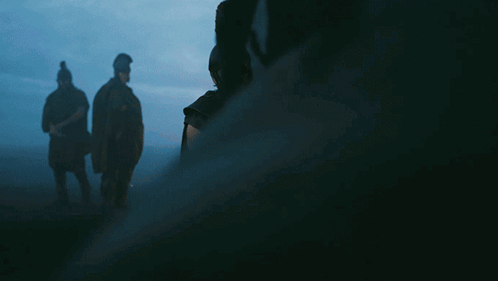 A Man In A Helmet Holds A Sword In His Hand GIF