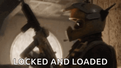 A Man In A Helmet Is Holding A Gun And The Words `` Locked And Loaded '' Are Visible . GIF