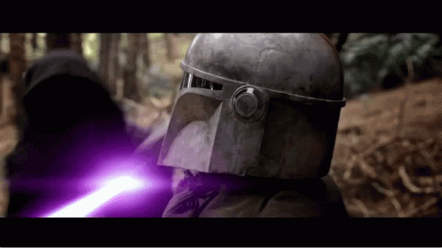 A Man In A Helmet Is Holding A Purple Lightsaber GIF