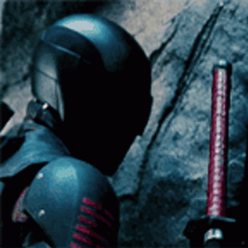 A Man In A Helmet Is Holding A Red Sword GIF