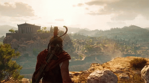 A Man In A Helmet Stands On Top Of A Hill Overlooking A Valley GIF