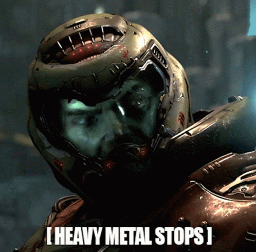 A Man In A Helmet With The Words Heavy Metal Stops Below Him GIF
