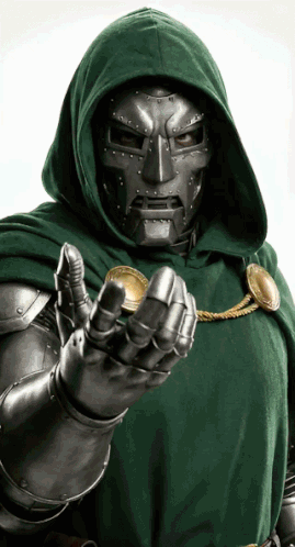A Man In A Hooded Cape Is Holding A Gold Coin GIF
