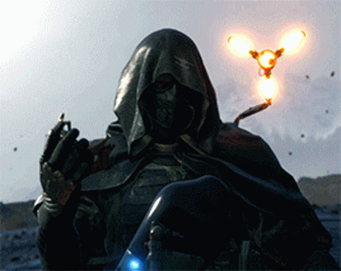 A Man In A Hooded Cape Is Holding A Light In Front Of Him GIF
