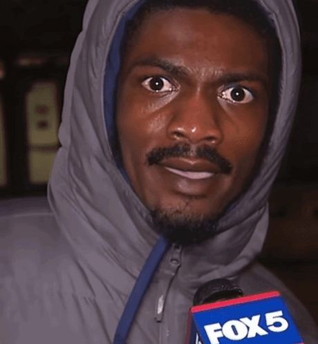 A Man In A Hooded Jacket Holds A Fox 5 Microphone In His Hand GIF