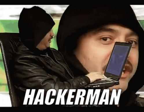 A Man In A Hooded Jacket Is Holding A Laptop And The Word Hackerman Is On The Screen GIF