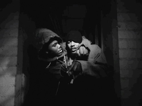 A Man In A Hooded Jacket Is Holding Another Man In A Hooded Jacket GIF