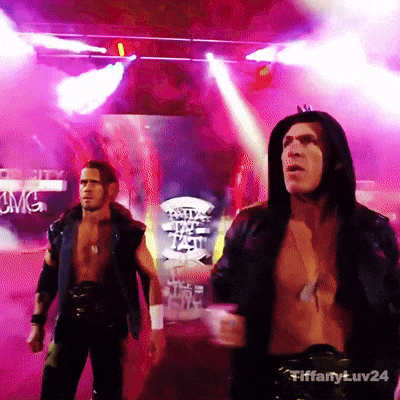 A Man In A Hooded Jacket Is Standing In Front Of A Sign That Says Cwc GIF