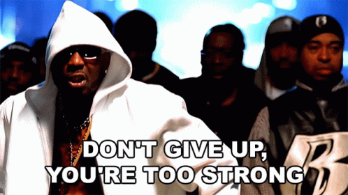 A Man In A Hooded Jacket Says " Don T Give Up You 'Re Too Strong " In Front Of A Crowd Of People GIF