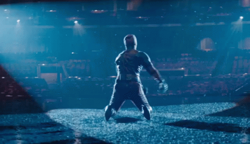 Man In Hooded Jacket Standing On Stage GIF