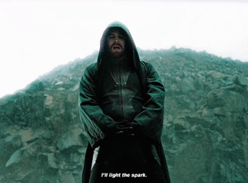 A Man In A Hooded Jacket With The Words " I 'Ll Light The Spark " Below Him GIF