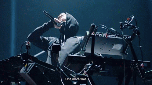 A Man In A Hooded Sweatshirt Playing A Keyboard That Says Advanc GIF