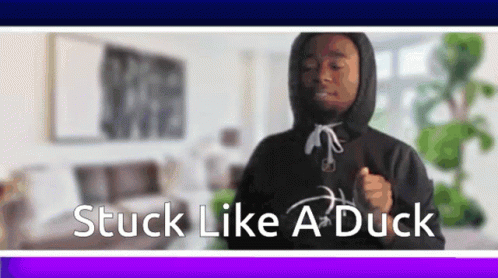 A Man In A Hoodie Is Dancing In A Living Room With The Words Stuck Like A Duck Below Him . GIF