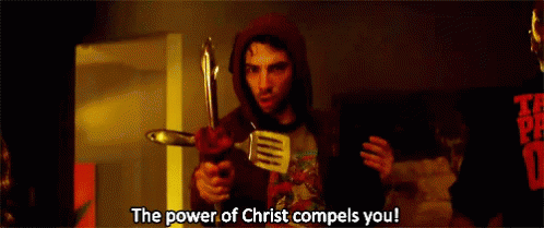 A Man In A Hoodie Is Holding A Spatula And A Knife And Says The Power Of Christ Compels You GIF