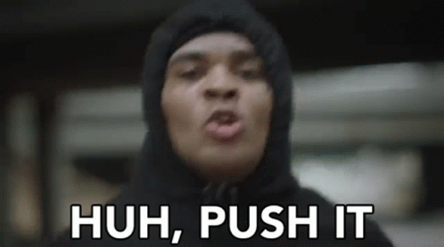 A Man In A Hoodie Is Making A Funny Face And Says `` Huh , Push It '' . GIF