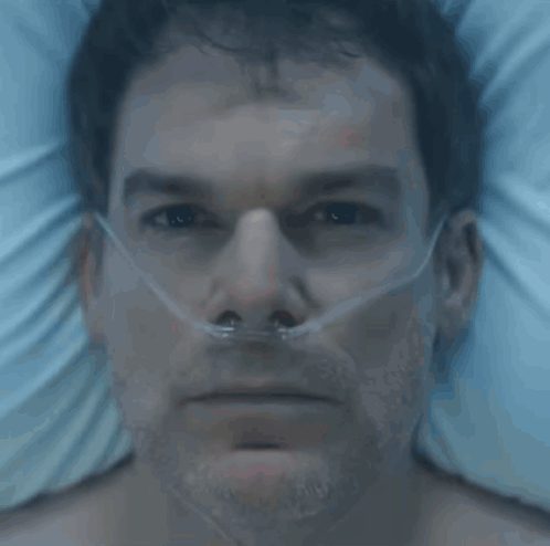 A Man In A Hospital Bed With An Oxygen Mask On His Nose GIF