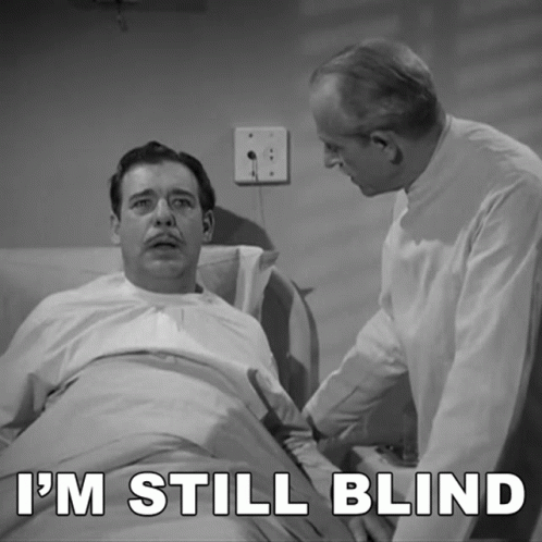 A Man In A Hospital Bed With The Words I 'M Still Blind GIF
