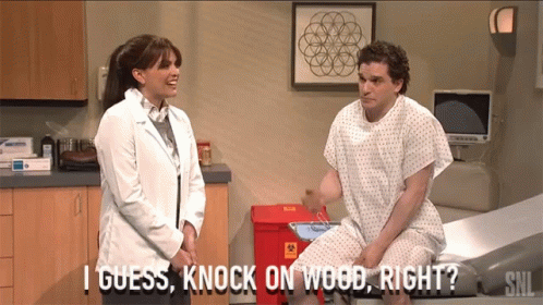 A Man In A Hospital Gown Is Talking To A Female Doctor Who Says I Guess Knock On Wood Right GIF