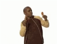 A Man In A Jacket Is Eating A Chicken Wing . GIF