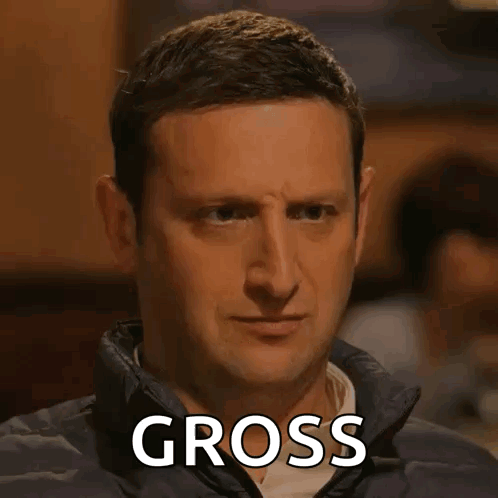 A Man In A Jacket Is Making A Funny Face With The Word Gross Written On His Face . GIF