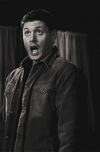 A Man In A Jacket Is Making A Surprised Face GIF