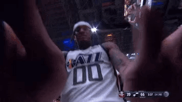A Man In A Jazz Jersey Is Taking A Selfie GIF