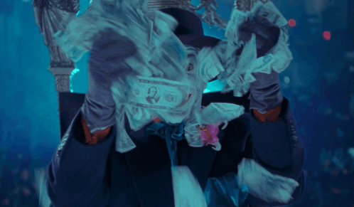 A Man In A Joker Costume With A Flower In His Tie GIF