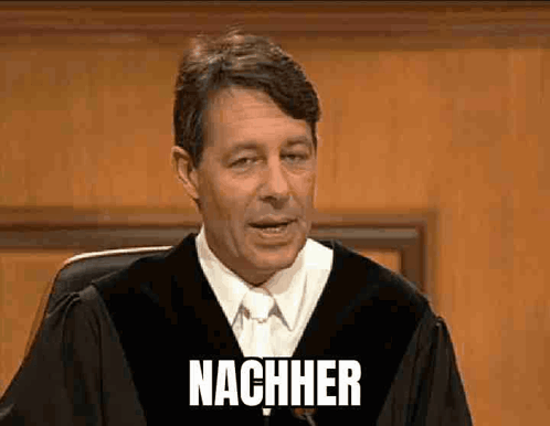A Man In A Judge 'S Robe Is Giving A Speech And The Word Nachher Is On The Screen Behind Him GIF