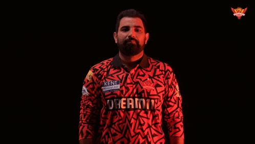 A Man In A Kent Shirt Is Holding A Ball GIF