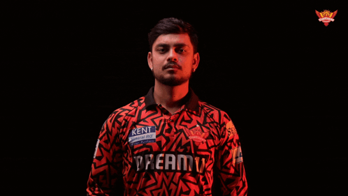 A Man In A Kent Shirt Is Holding A Bat GIF