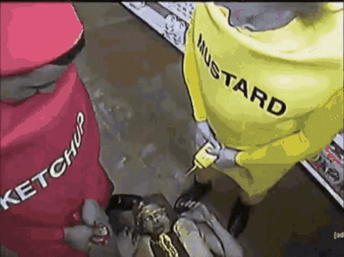 A Man In A Ketchup And Mustard Costume Is Holding A Gun GIF