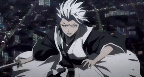 A Man In A Kimono Is Holding A Sword In Front Of A City . GIF