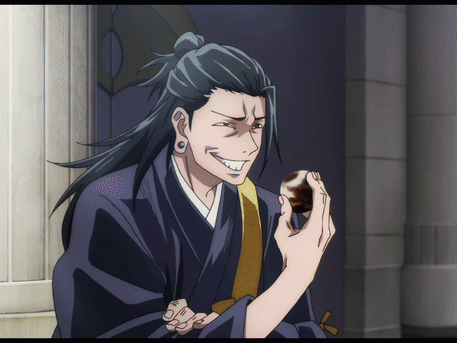A Man In A Kimono Is Holding Something In His Hand GIF